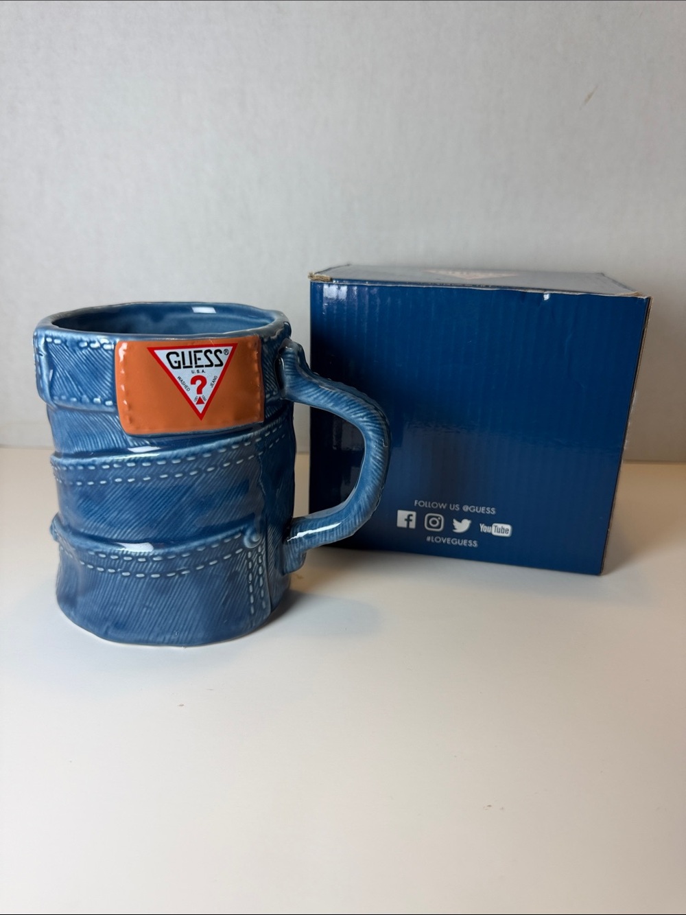 GUESS Blue Denim-Style Mug with Orange Logo Patch